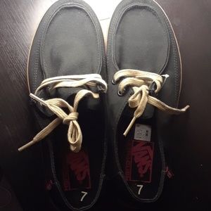 Black vans with tan bottoms and laces